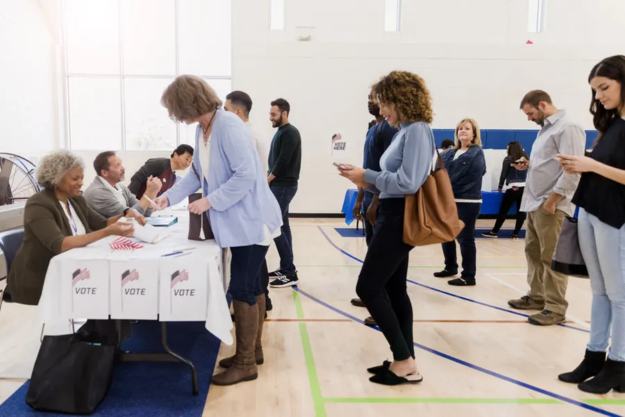 People standing in line waiting to vote.